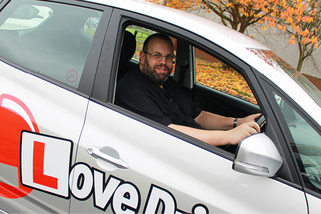 Richard Darby in the driver’s seat of the instructor car seen through an open window Richard Darby in the driver's seat of the instructor car seen through an open window. Our instructors have over 50 years' combined experience.