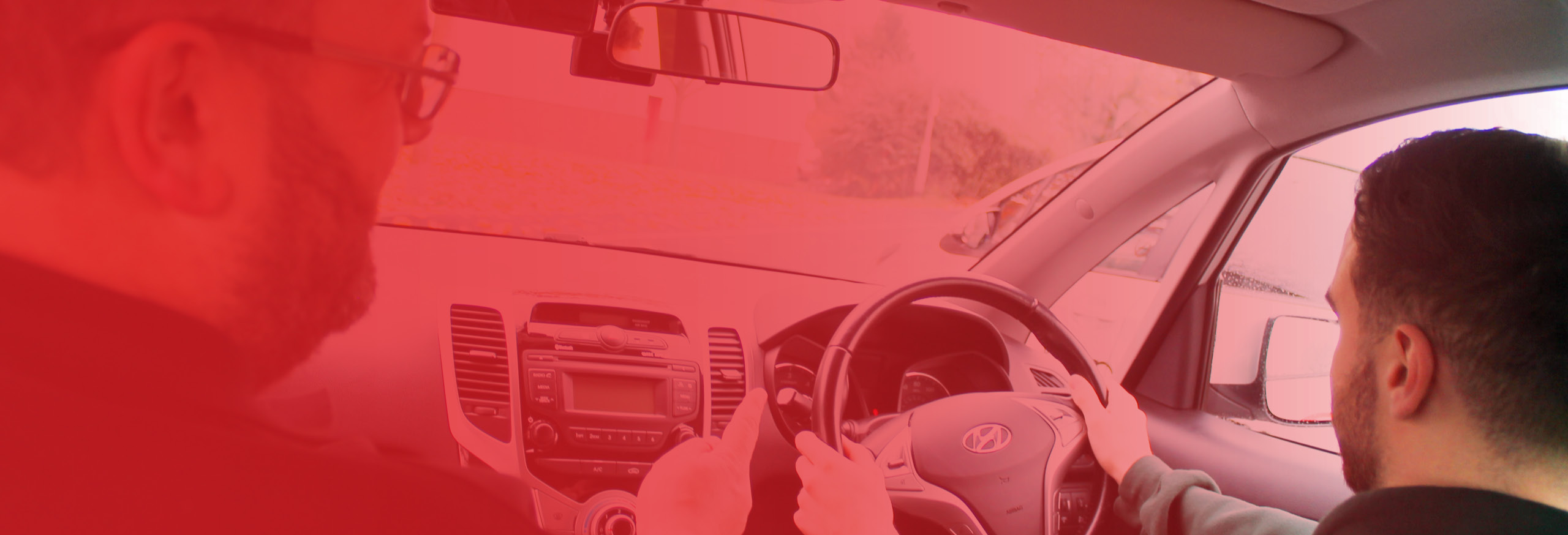 Richard Darby instructing male student from the passenger seat. Our instructors have over 50 years' combined experience.