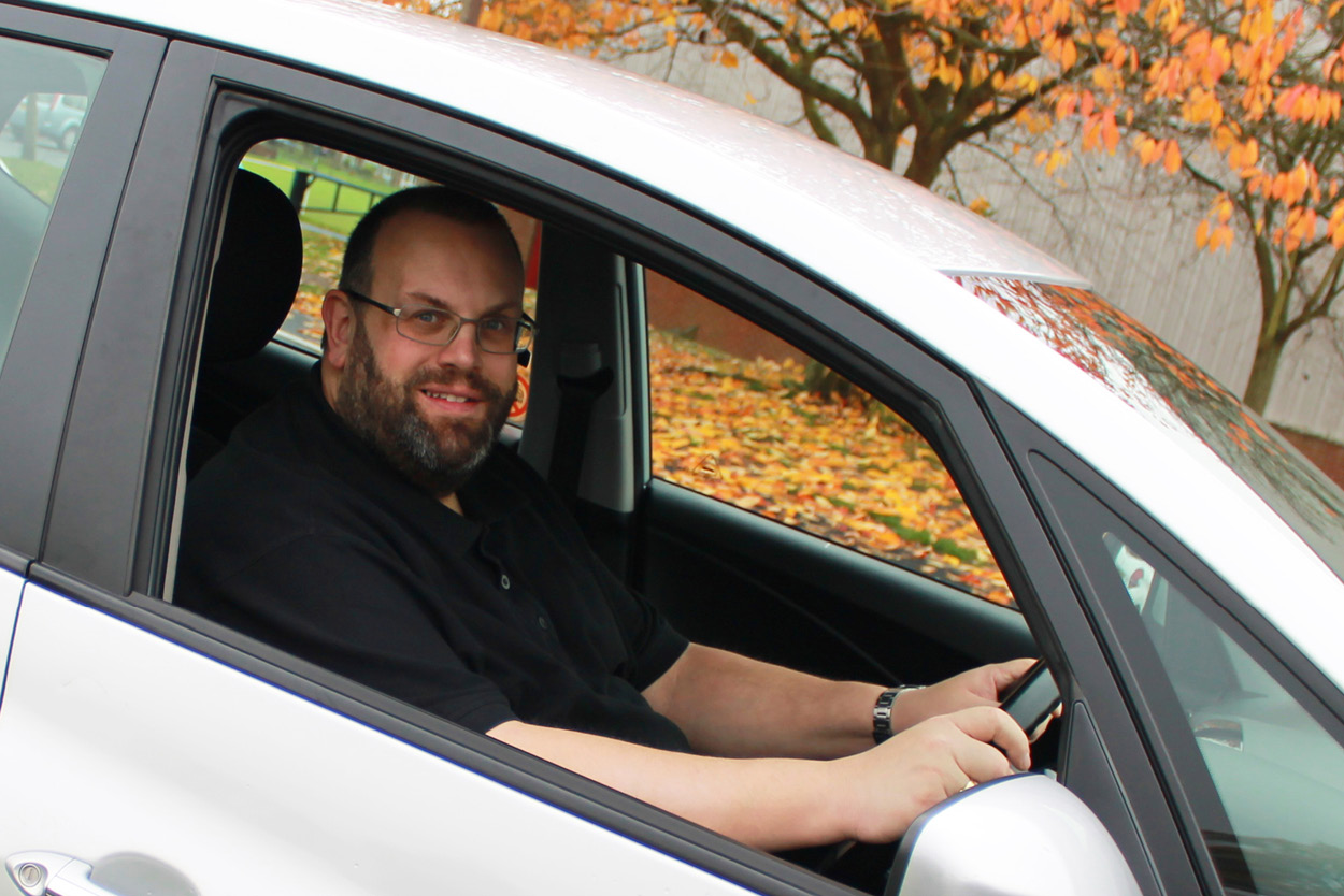 Richard Darby in the driver's seat of the instructor car seen through an open window