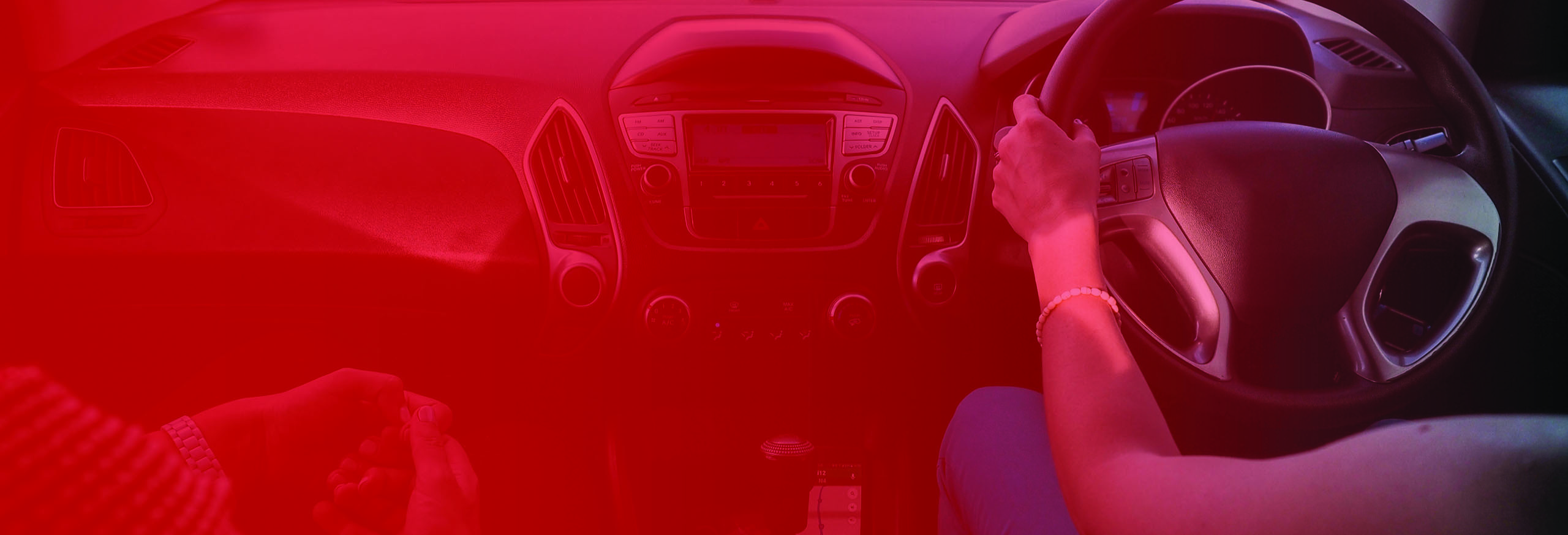 Full dashboard of modern car with lady driver's hands on the steering wheel. Automatic Driving Lessons in Worcester.